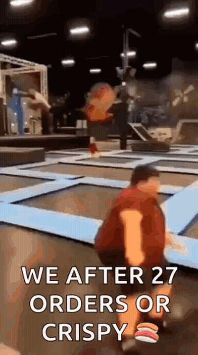 A Man Is Kneeling On A Trampoline With The Words `` We After 27 Orders Or Crispy '' Written On It . GIF