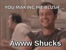 A Man Is Laughing And Making A Funny Face While Sitting At A Table . GIF