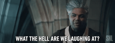 A Man Is Laughing At Something While Wearing A White Hat And A Black Shirt . GIF
