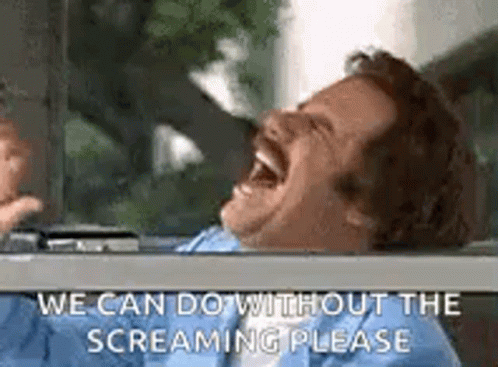 A Man Is Laughing In A Car With His Mouth Open And Says `` We Can Do Without The Screaming Please '' . GIF