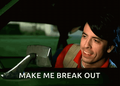 A Man Is Laughing In A Car With The Words Make Me Break Out Above Him GIF