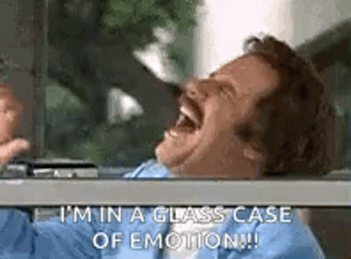 A Man Is Laughing In A Glass Case Of Emotion While Sitting In A Car . GIF