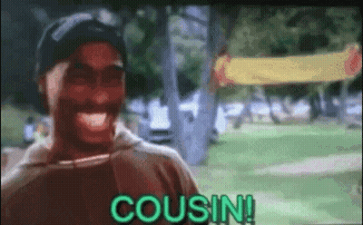 A Man Is Laughing In A Park With The Word Cousin Written On The Screen . GIF
