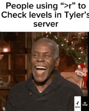 A Man Is Laughing In Front Of A Christmas Tree GIF