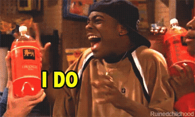A Man Is Laughing While Holding A Bottle Of Orange Soda And Says I Do GIF