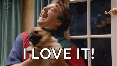 A Man Is Laughing While Holding A Dog In His Arms And Saying `` I Love It '' . GIF