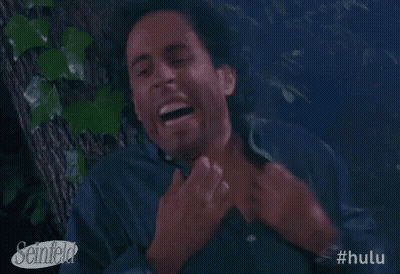 A Man Is Laughing While Sitting In A Tree . GIF