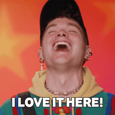 A Man Is Laughing With The Words " I Love It Here " Behind Him GIF