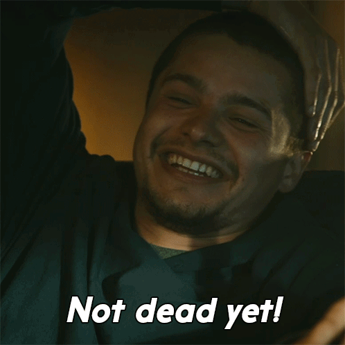 A Man Is Laughing With The Words Not Dead Yet Written Below Him GIF