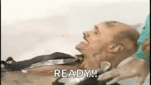 A Man Is Laying In A Bathtub With A Knife In His Neck And Says `` Ready ! '' GIF