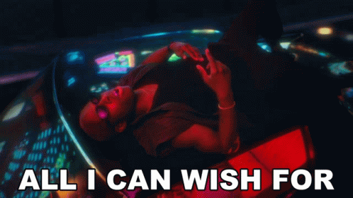 A Man Is Laying In A Car With The Words All I Can Wish For GIF