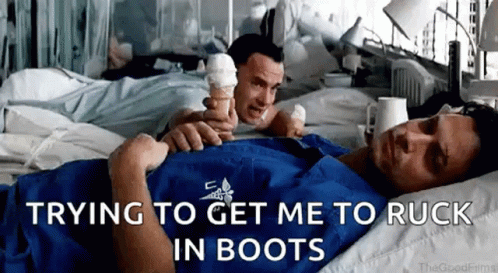 A Man Is Laying In A Hospital Bed While Another Man Holds An Ice Cream Cone Over His Head . GIF