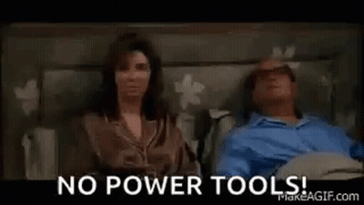A Man Is Laying In A Hospital Bed With A Woman . GIF