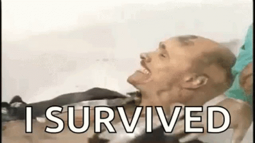 A Man Is Laying In A Hospital Bed With The Words `` I Survived '' Written Above Him . GIF
