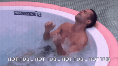 A Man Is Laying In A Hot Tub With The Words Hot Tub Written On The Bottom GIF
