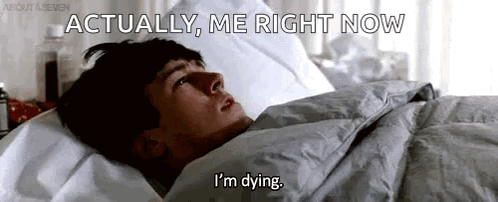 A Man Is Laying In Bed With The Words `` Actually , Me Right Now I 'M Dying '' Written On The Screen . GIF