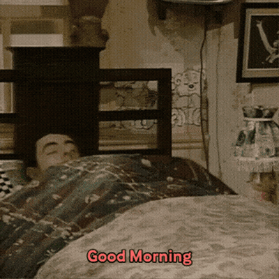 A Man Is Laying In Bed With The Words " Good Morning " Written On The Bottom GIF