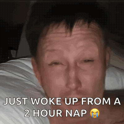 A Man Is Laying In Bed With The Words Just Woke Up From A 2 Hour Nap GIF