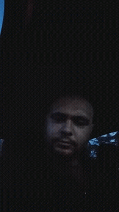 A Man Is Laying In The Dark With His Eyes Closed GIF