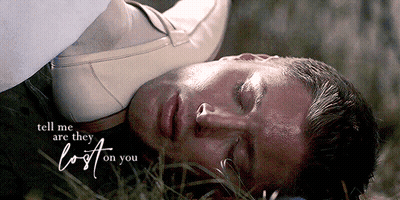 A Man Is Laying In The Grass With The Words Tell Me Are They Lost On You GIF