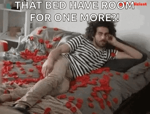 A Man Is Laying On A Bed Covered In Rose Petals And Says That Bed Have Room For One More GIF