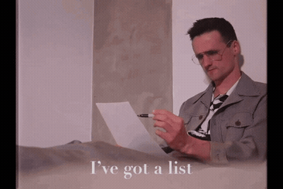 A Man Is Laying On A Bed Holding A Piece Of Paper With The Words I 'Ve Got A List Written Below Him GIF