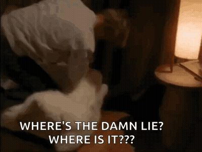 A Man Is Laying On A Bed With A Pillow And A Lamp And Says Where 'S The Damn Lie ? GIF