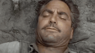 A Man Is Laying On A Bed With His Eyes Closed And The Words `` Good Morning '' Written Above Him . GIF