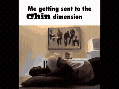 A Man Is Laying On A Bed With His Head On A Pillow And A Picture On The Wall Behind Him . GIF