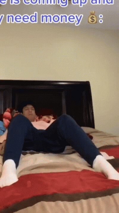 A Man Is Laying On A Bed With The Words " I Need Money " In The Corner GIF