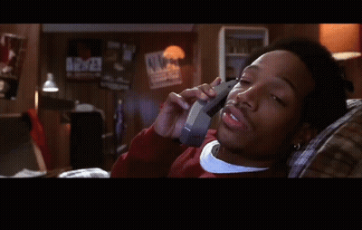 A Man Is Laying On A Couch Talking On A Cell Phone With The Word True Below Him GIF