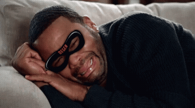 A Man Is Laying On A Couch Wearing A Mask That Says Degen On It GIF