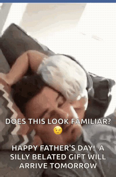 A Man Is Laying On A Couch With A Baby On His Head . GIF