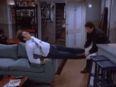 A Man Is Laying On A Couch With His Legs Up GIF