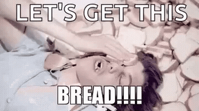 A Man Is Laying On A Pile Of Bread With His Hand On His Face . GIF