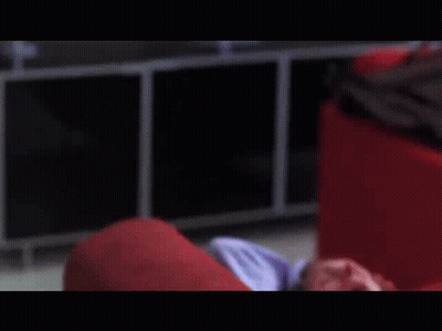A Man Is Laying On A Red Couch With His Eyes Closed GIF