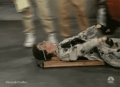 A Man Is Laying On A Wooden Plank With A Nbc Logo On The Bottom GIF