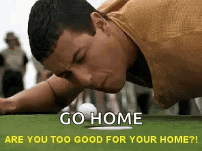 A Man Is Laying On His Stomach On A Golf Course With A Golf Ball . GIF