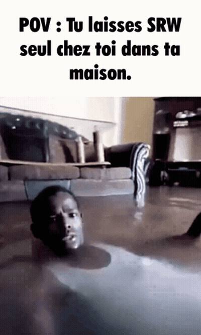 A Man Is Laying On The Floor In A Flooded Living Room GIF