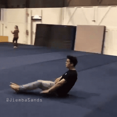 A Man Is Laying On The Floor In A Gym With The Words Juliembasands Written On The Bottom GIF