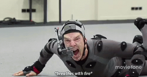 A Man Is Laying On The Floor Wearing A Helmet And Knee Pads And Breathing With Fire . GIF