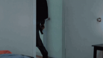 A Man Is Laying On The Floor With Blood On His T-Shirt GIF
