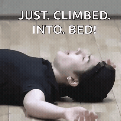 A Man Is Laying On The Floor With The Words Just Climbed Into Bed Written Above Him GIF