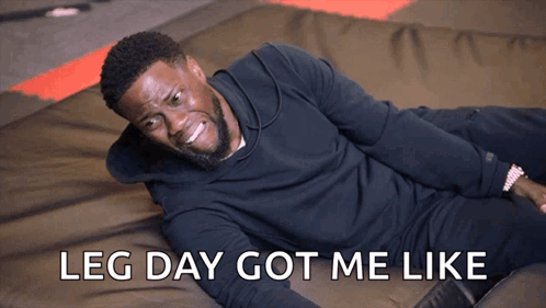 A Man Is Laying On The Floor With The Words Leg Day Got Me Like Behind Him GIF