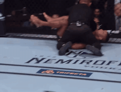 A Man Is Laying On The Ground In A Boxing Ring With A Nemiroff Logo On The Floor GIF