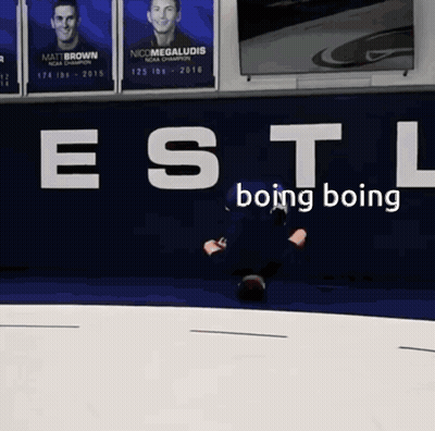 A Man Is Laying On The Ground In Front Of A Wall That Says " Estl Boing Boing " GIF
