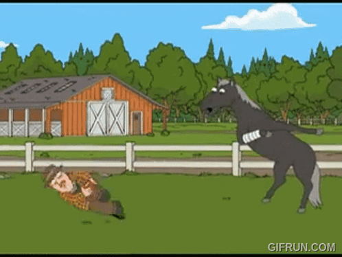 A Man Is Laying On The Ground While A Horse Stands On Its Hind Legs GIF