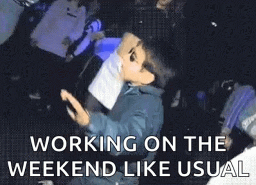 A Man Is Laying On The Ground With A Puppet On His Head And The Words `` Working On The Weekend Like Usual '' . GIF