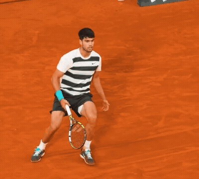 A Man Is Laying On The Ground With A Tennis Racquet On The Ground GIF