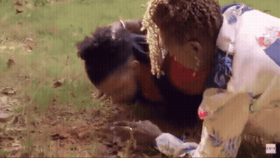 A Man Is Laying On The Ground With A Woman Standing Next To Him With A Bbc Logo In The Corner GIF